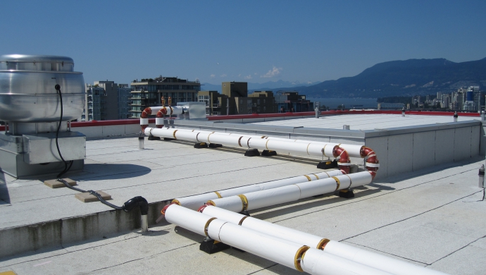 Rooftop piping installation while under construction